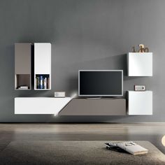 a modern living room with grey walls and white entertainment center in the middle, along with bookshelves on either side