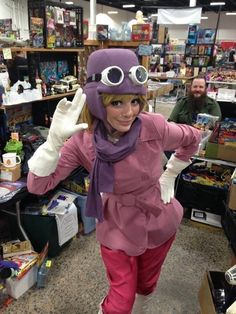 a woman dressed in pink and purple poses for the camera