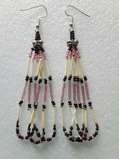 two pairs of beaded earrings with pink and white beads hanging from the end of them