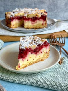 a slice of cheesecake on a plate with powdered sugar