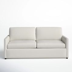 a white couch sitting on top of a white floor