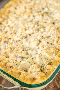 a casserole dish with cheese and meat in it on a wooden table top