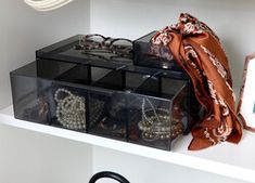 the shelf is filled with many pairs of shoes and bags, including one for purses