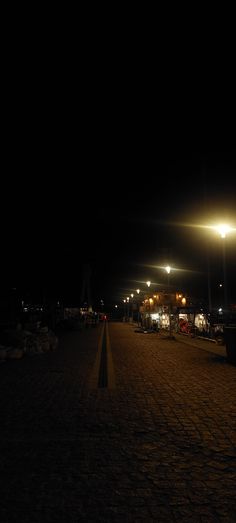 an empty parking lot at night with street lights