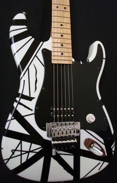 an electric guitar with black and white designs on it