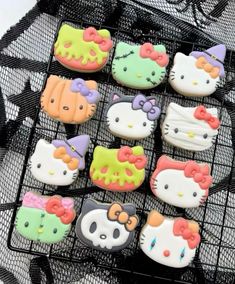 hello kitty cookies are sitting on a wire rack