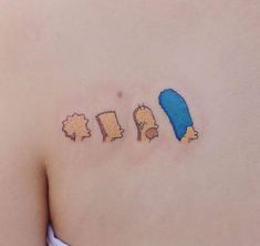 the back of a woman's shoulder with three cartoon characters on it