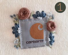 a close up of a piece of cloth with flowers on it and the words cannari