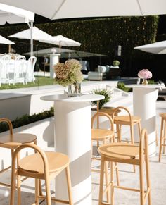 tables and chairs with umbrellas in the background