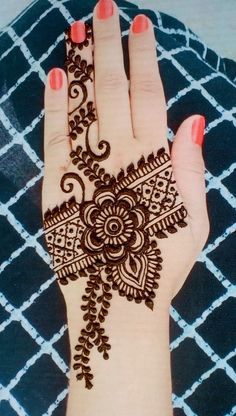 a woman's hand with henna on it