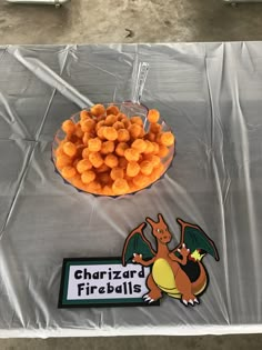 a table topped with a bowl of cheese balls and a dragon sticker next to it