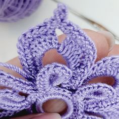 someone is crocheting an object with yarn