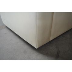 a white couch sitting on top of a carpeted floor