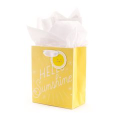 a yellow hello sunshine gift bag with tissue paper on it's side and the words hello sunshine written in white