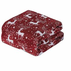 a red blanket with white deers and snowflakes on it, in front of a white background