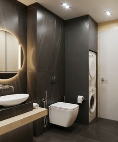 a bathroom with a toilet, sink, and mirror in it's center wall