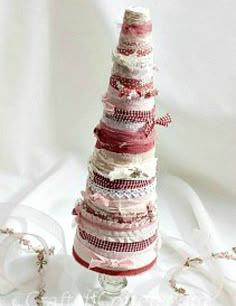 a stack of ribbons sitting on top of a glass vase next to a white ribbon