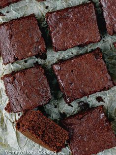 chocolate brownies sitting on top of wax paper