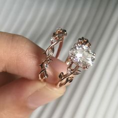 a person is holding two rings with diamonds on them and the other one has a diamond in it