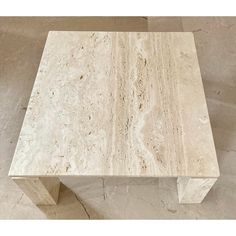 a white marble coffee table sitting on top of a floor