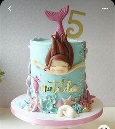 a birthday cake with a little mermaid on top