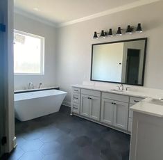 a large bathroom with two sinks and a bathtub