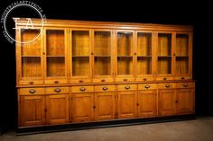 an old wooden bookcase with many drawers and cupboards on it's sides