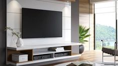 a large flat screen tv mounted to the side of a wall in a living room