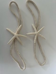 two white starfishs are tied together on a table