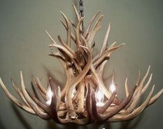 a deer antler chandelier with candles in it