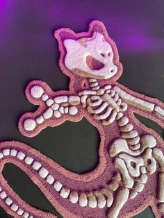 an image of a stuffed animal made to look like a human skeleton on a purple background