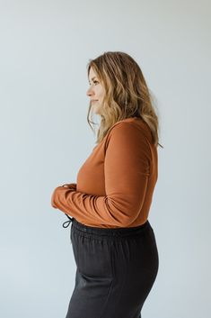 Look good and feel amazing with this mid and plus-size ribbed V-neck bodysuit! The lightweight knit fabric is ultra-comfy, and the functional snaps make getting dressed a cinch. Plus, with its unique ribbed texture, you'll be turning heads everywhere you go! Get ready to rock a head-to-toe look that’s as chic as it is stylish! Misty is wearing a size 1x. Want more information about the model? Visit our Lovely Models page. Wash Hand wash cold. Hang to dry. Fabric 97% Polyester 3% Spandex Measurements Size Bust Arm Body Length Sleeve Length 1x 42" 13" 22" 27.5" 2x 44" 14" 22.5" 28" 3x 46" 15" 23" 28.5" *We understand that each body type is different, so posted above are measurements. These measurements are taken from one garment; however, garments even in the same size may vary slightly. If Casual Bodysuit For Layering, Casual Solid Bodysuit For Layering, Casual V-neck Bodysuit For Fall, Fitted Brown V-neck Knit Top, Stretch V-neck Knit Top With Ribbed Neckline, Stretch V-neck Top With Ribbed Neckline, Ribbed Stretch V-neck Sweater, Brown Seamless V-neck Top, V Neck Bodysuit