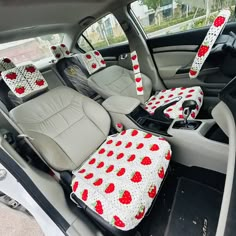 the interior of a car is decorated with cherries and polka dots, as well as seat covers