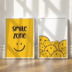 two framed posters with smiley faces on them, one saying smile zone and the other saying happy