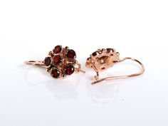 These 14K Rose gold Garnet earrings are handcrafted in a dainty floral design. One red garnet is in the middle, encircled by five garnet tones, creating a delicate flower. The rose gold blends in with the red garnet. Details and Measurements: ► 14 Karat Rose Gold ► Total Weight 4.19 gr ► 12 Garnet stones 4 mm All items are Handmade, I pay a lot of attention for every detail in the jewelry I design. All of my items are hand crafted in Kisufim's Designer jewelry Store in Tel Aviv, and shipped dire Elegant Cluster Gemstone Earrings, Cluster Yellow Gold Earrings For Gifts, Fine Jewelry Cluster Earrings As Gift, Luxury Wedding Earrings With Lever Back Ear Wires, Jewelry Rose Gold, Anniversary Gift For Wife, Garnet Earrings, Anniversary Gifts For Wife, Garnet Stone