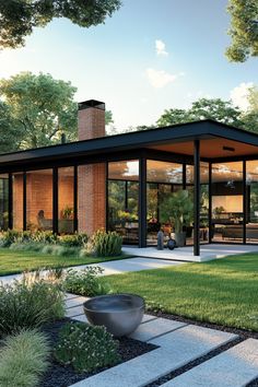 a modern house with glass walls and lots of grass