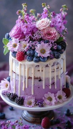 a cake with flowers and berries on top