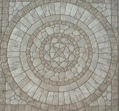 an image of a circular stone pattern on the ground