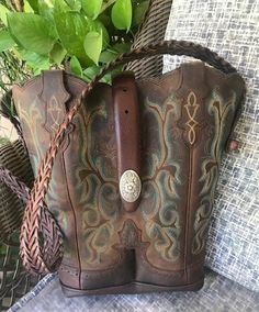 Embroidery stitch Cowboy Boot Purse. Made from gently used cowboy boots, Gently used braided leather belt for strap, new concho buckle, snap closure and lined with brown waterproof canvas for easy clean. Body of purse is 12" high by 11" wide at top Hand-tooled Brown Country Boots, Western Brown Bags For Rodeo, Western Style Brown Bags For Rodeo, Western Style Brown Bag With Concho, Western Style Hand Tooled Brown Bag, Brown Leather Bags For Rodeo, Hand Tooled Brown Bags For Rodeo, Western Leather Bags For Rodeo, Brown Hand Tooled Bag For Rodeo