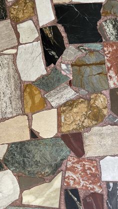 an assortment of different colored stone tiles