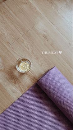 a yoga mat and a glass of water on the floor