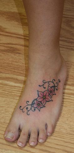 a woman's foot with a flower tattoo on it