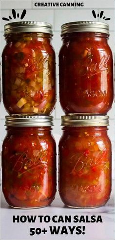 four jars filled with pickled vegetables sitting next to each other on top of a table