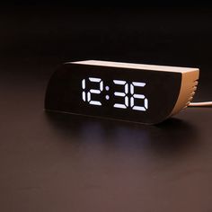 an alarm clock sitting on top of a table