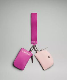 two luggage tags attached to each other on a lanyard or keychain, one pink and the other light pink