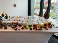 a table topped with cups filled with different types of drinks and condiments on top of it