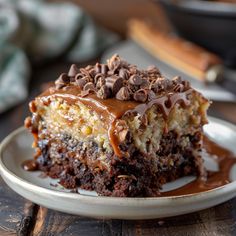 a piece of cake on a plate with chocolate sauce drizzled over it