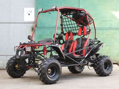 an off - road buggy with red seats is parked in front of a building