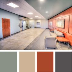 the interior of an office building with wood paneling and gray walls, white furniture, and orange accents