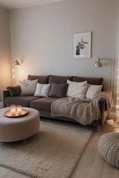 the living room is clean and ready to be used for christmas time, with candles lit on the coffee table